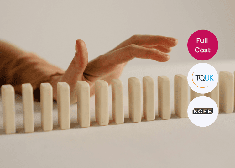 Hand reaching toward a row of upright domino tiles on a table, suitable for risk management or decision making training.