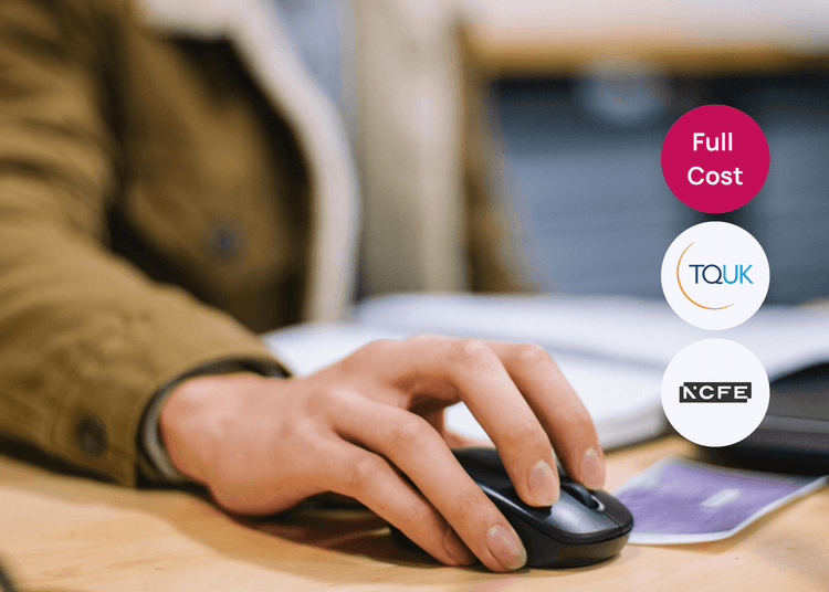 Hand using a computer mouse beside paperwork on a desk, suitable for business administration or digital skills training.