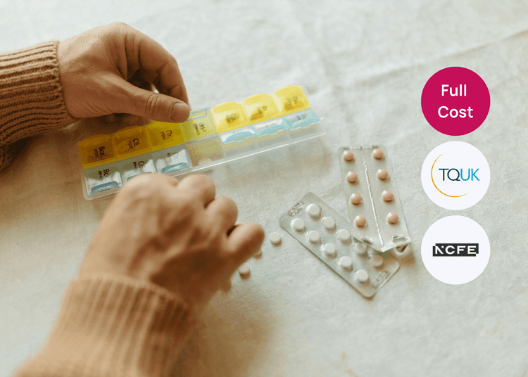 Hands sorting tablets into a weekly pill organiser with blister packs on the table for medication training.