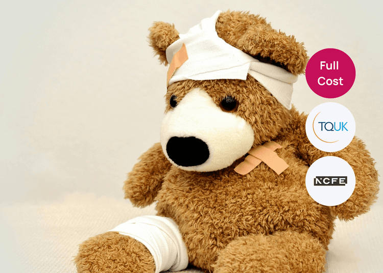 Teddy bear with bandages on its head and leg, used as a prop for first aid training with children.