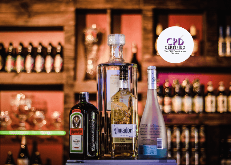 4 different types of alcohol on display in a pub setting, with a full bar of spirits blurred in the background.
