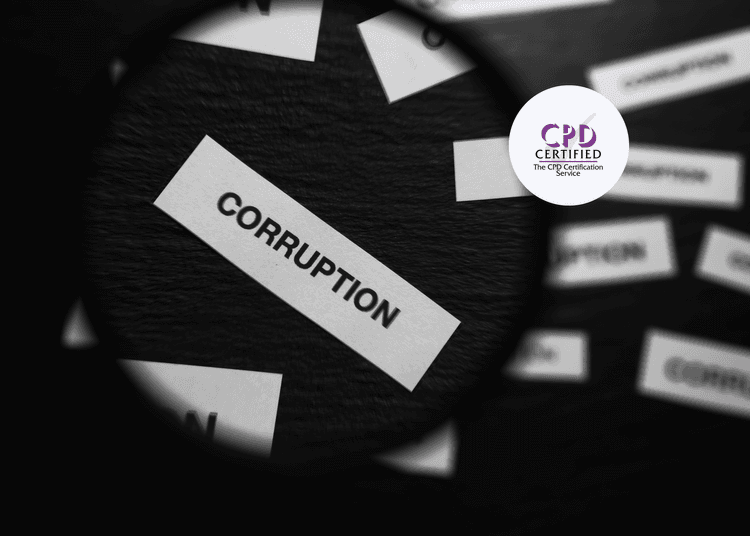 The word “CORRUPTION” printed on a paper slip, viewed through a magnifying glass on a dark surface.