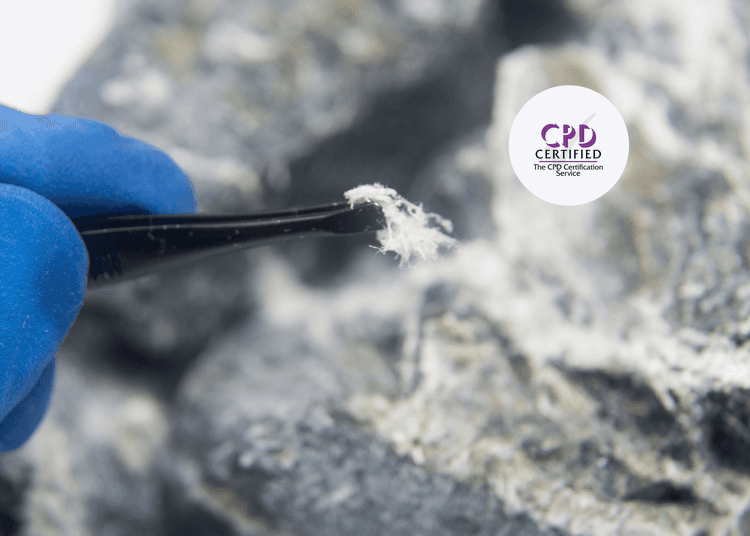 Person wearing blue safety gloves picking up a white fluffy substance with tweezers.