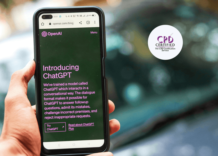 Close-up of a hand holding a smartphone showing the ChatGPT introduction page on the OpenAI website screen.