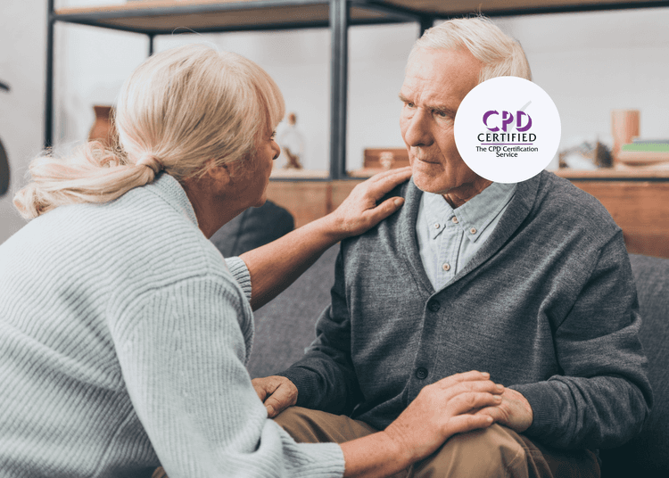 Elderly woman gently comforting an elderly man, both seated and engaged in a caring conversation at home.