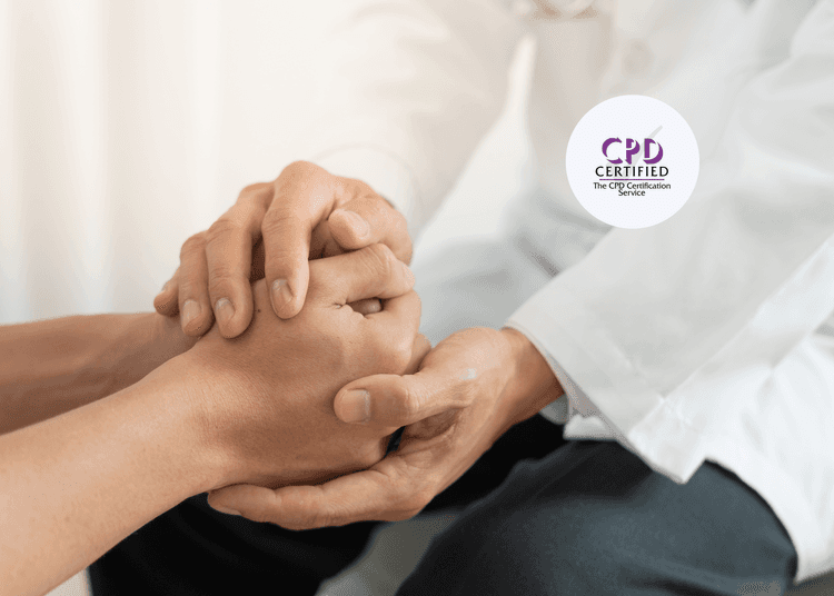 Close-up of a healthcare professional in a white coat gently holding a person's hands in a comforting gesture.
