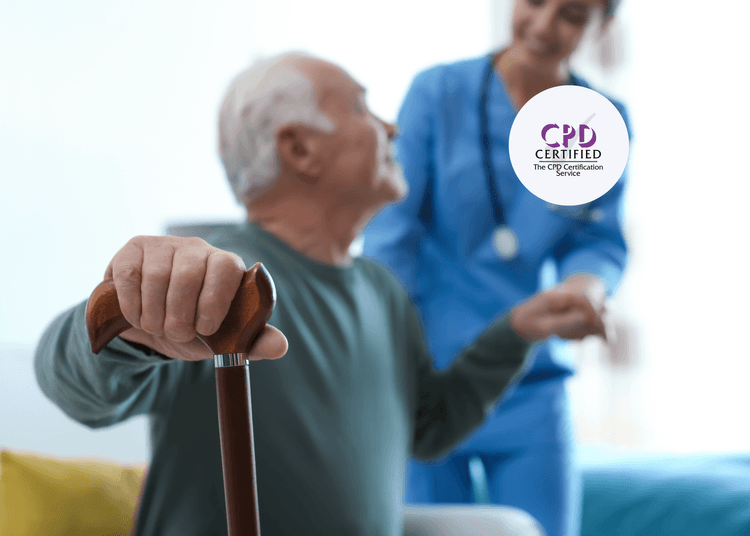 Elderly man holding a wooden walking stick while a smiling nurse in blue scrubs offers support in the background.