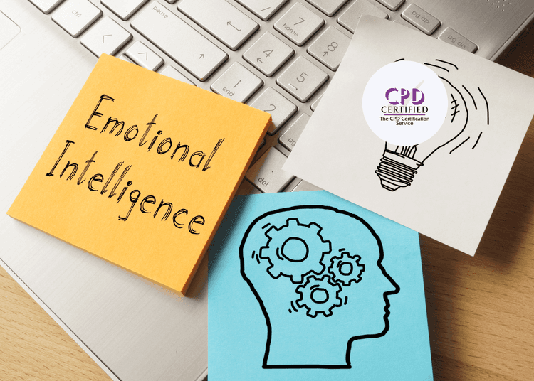 Sticky notes on a keyboard showing “Emotional Intelligence,” a lightbulb, and a head with gears inside.