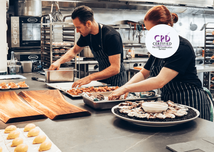 Chefs in a professional kitchen preparing food, promoting CPD-certified Level 1 Food Safety training in a catering setting.