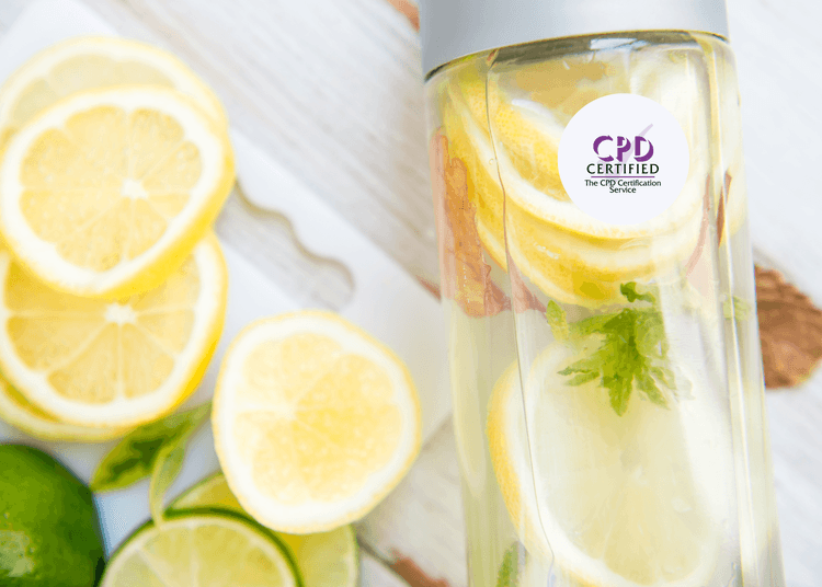 Slices of lemon and lime beside a water bottle filled with lemon, mint, and herbs on a wooden surface.