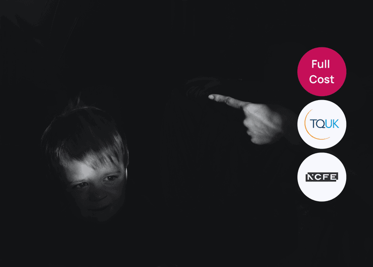 Child in low light with an adult hand pointing toward them related to bullying awareness.