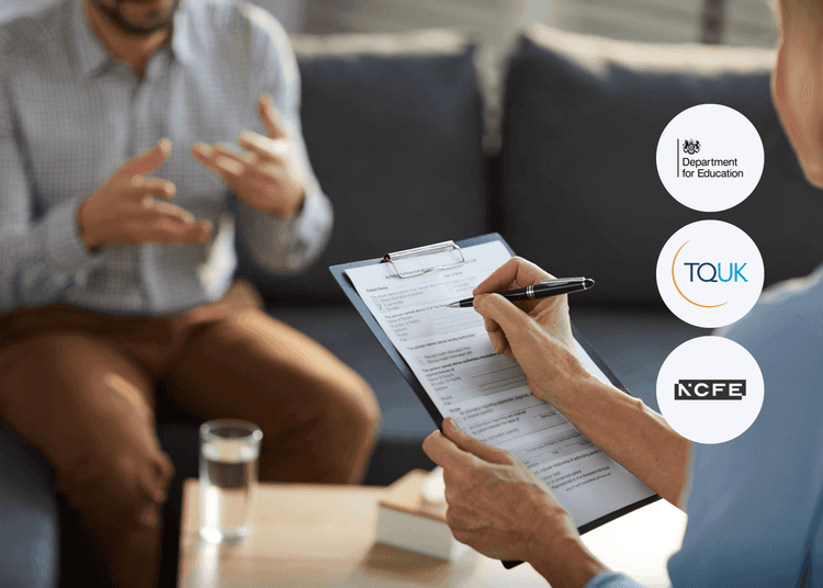 Therapist writing on a clipboard while a seated man gestures with his hands during a counselling session.