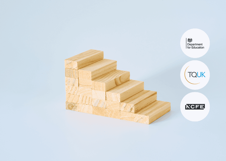 Stacked wooden blocks arranged into a staircase shape on a plain surface, viewed from the side.