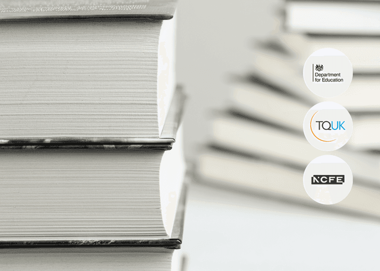 Close-up of stacked hardcover books with textured white pages and blurred books in the background.
