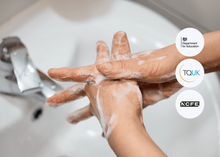 Close-up of hands being thoroughly scrubbed with soap under a tap, with lather covering both hands.