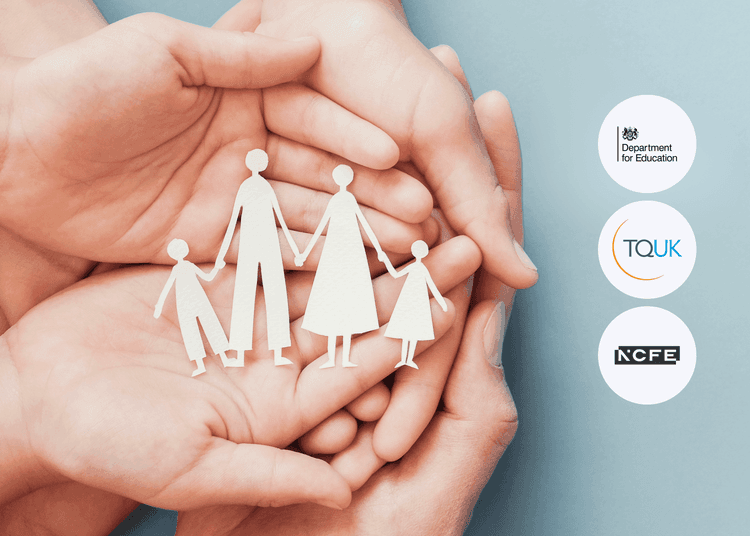 Adult hands gently holding paper cutouts of a family of four, placed against a soft blue background in close-up view.