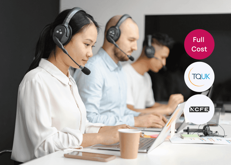 Team of headset wearing advisers working at laptops, reflecting a busy customer service training environment. Call centre staff wearing headsets and working on laptops at a shared desk for customer service training.