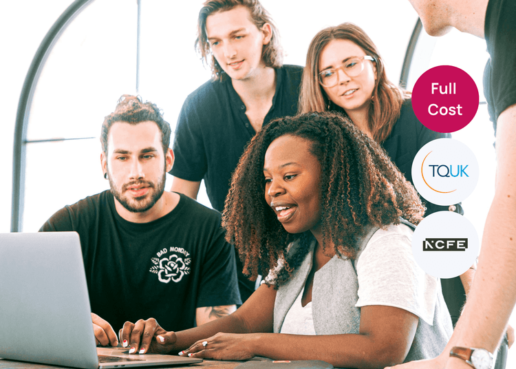 Team working together around a laptop, illustrating collaborative learning and group problem solving. Group of young adults gathered around a laptop, collaborating on a task in a bright workspace.