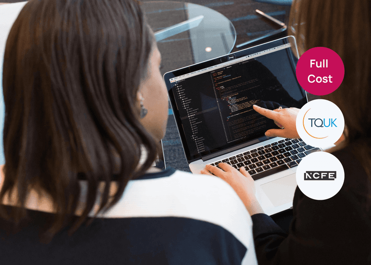 Discussing and reviewing code together on a laptop, supporting collaborative learning in digital skills. Two people reviewing lines of code on a laptop screen, with one person pointing to a section for clarification.