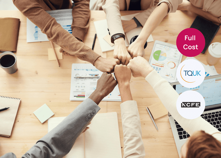 Team members join fists in a show of unity, highlighting the collaborative focus of leadership and team leading training. Group of colleagues joining fists over a desk covered with charts and notebooks, representing teamwork and leadership training.