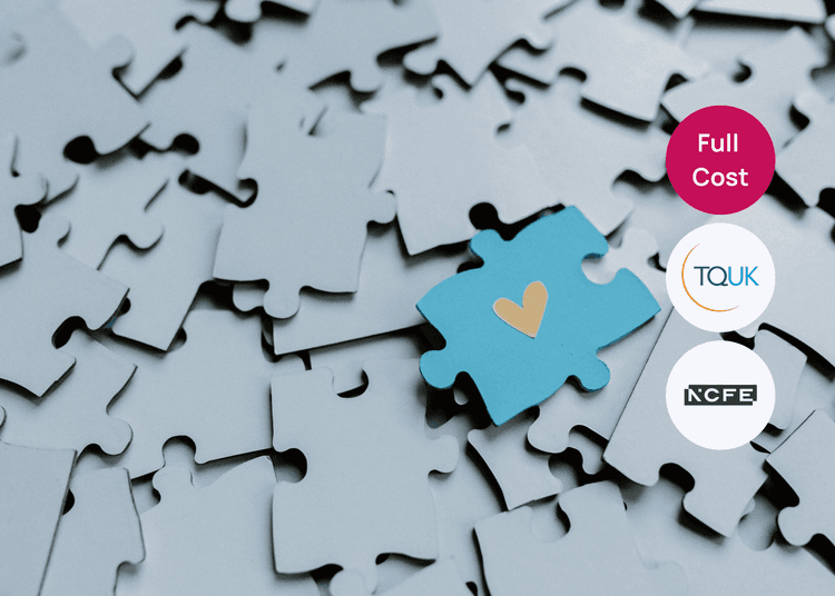 A standout blue puzzle piece among others, linking to themes of support and care within wellbeing training. Pile of grey puzzle pieces with one blue piece showing a small heart symbol near the centre.